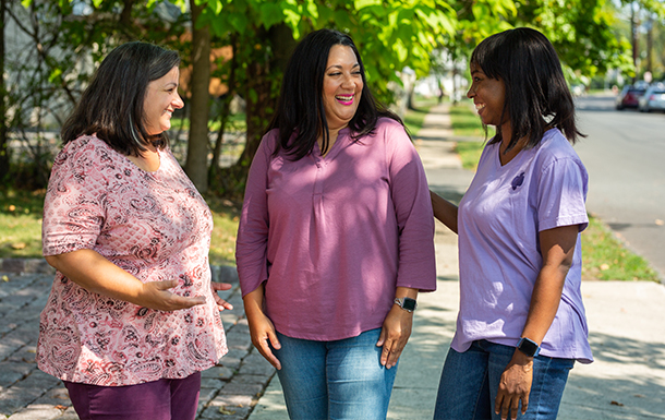 adult woman standing in front of a tree