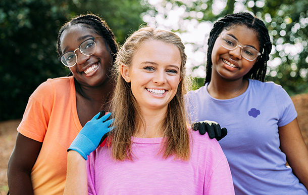 Group of older girl scouts smiling together.